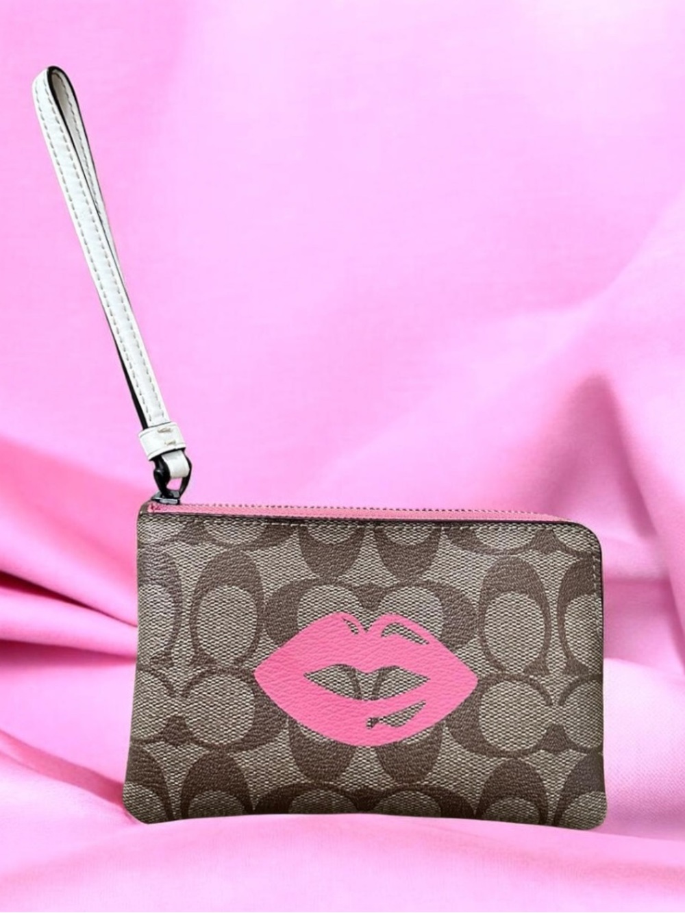 Coach Brown Signature Wristlet with Pink Lip Print near new